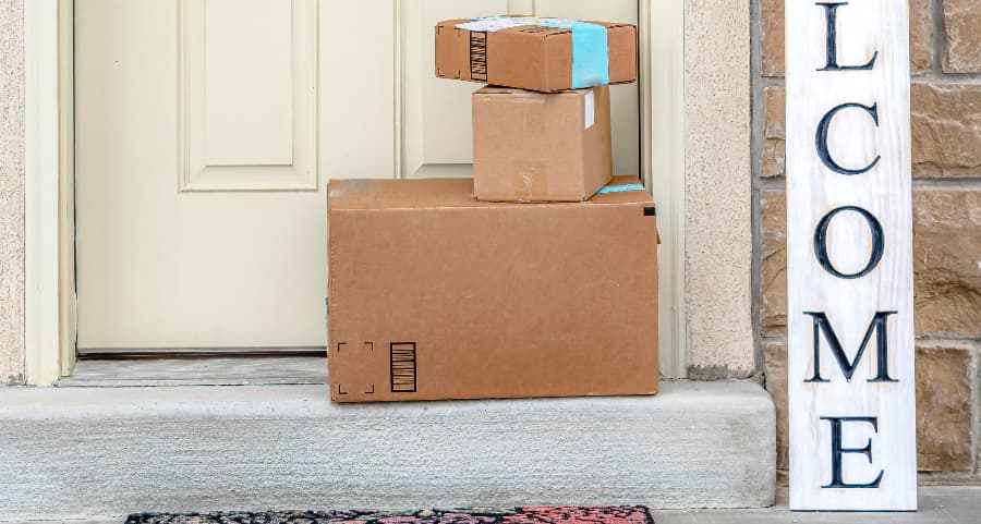 Packages on the doorstep of a home with a welcome sign in Seattle